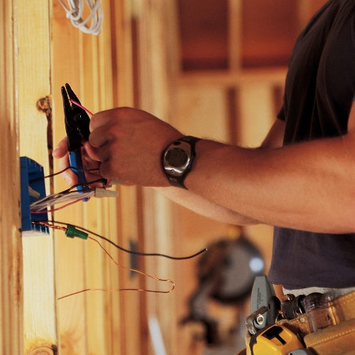 An outlet being installed by an electrician.